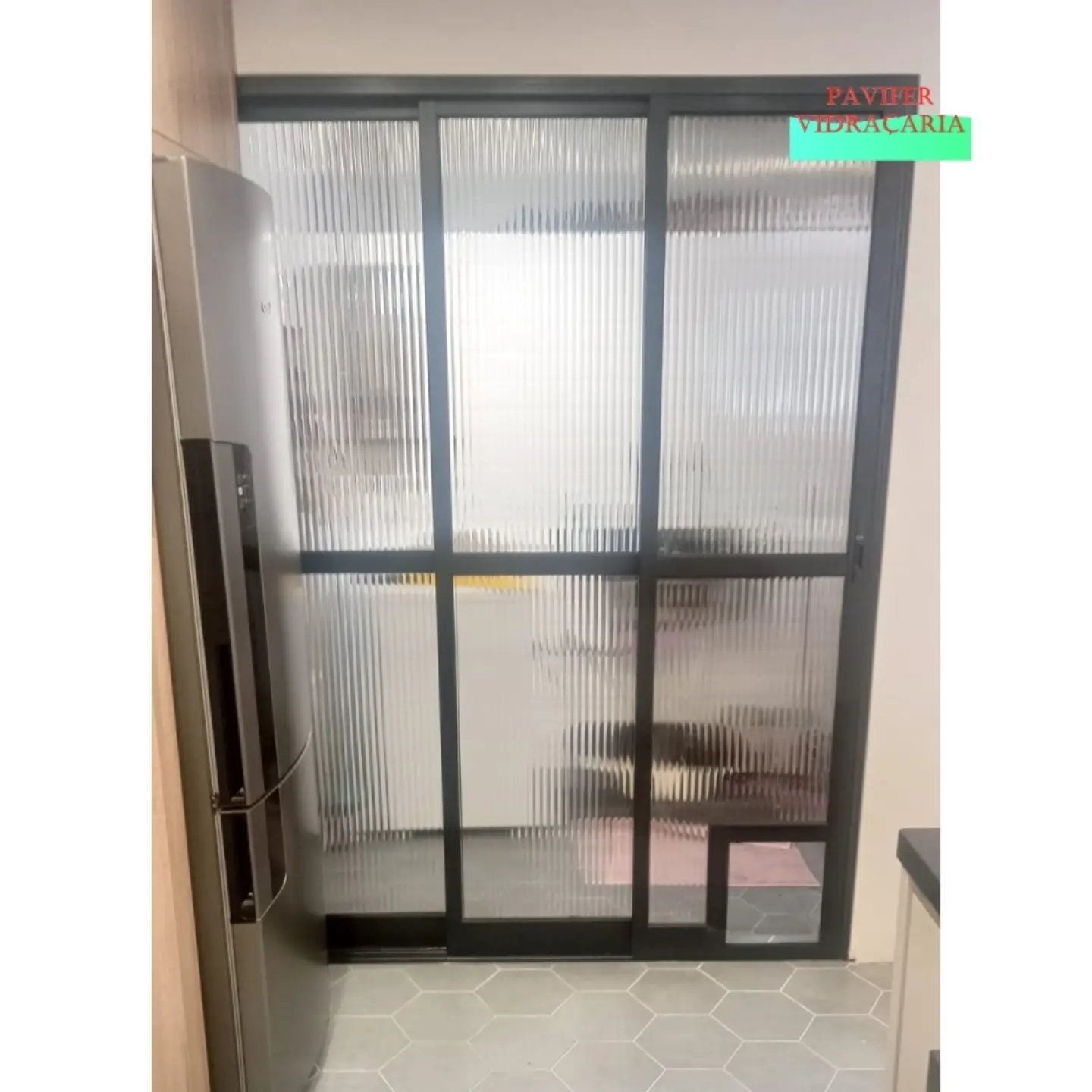 Porta de correr em vidro canelado dividindo a cozinha